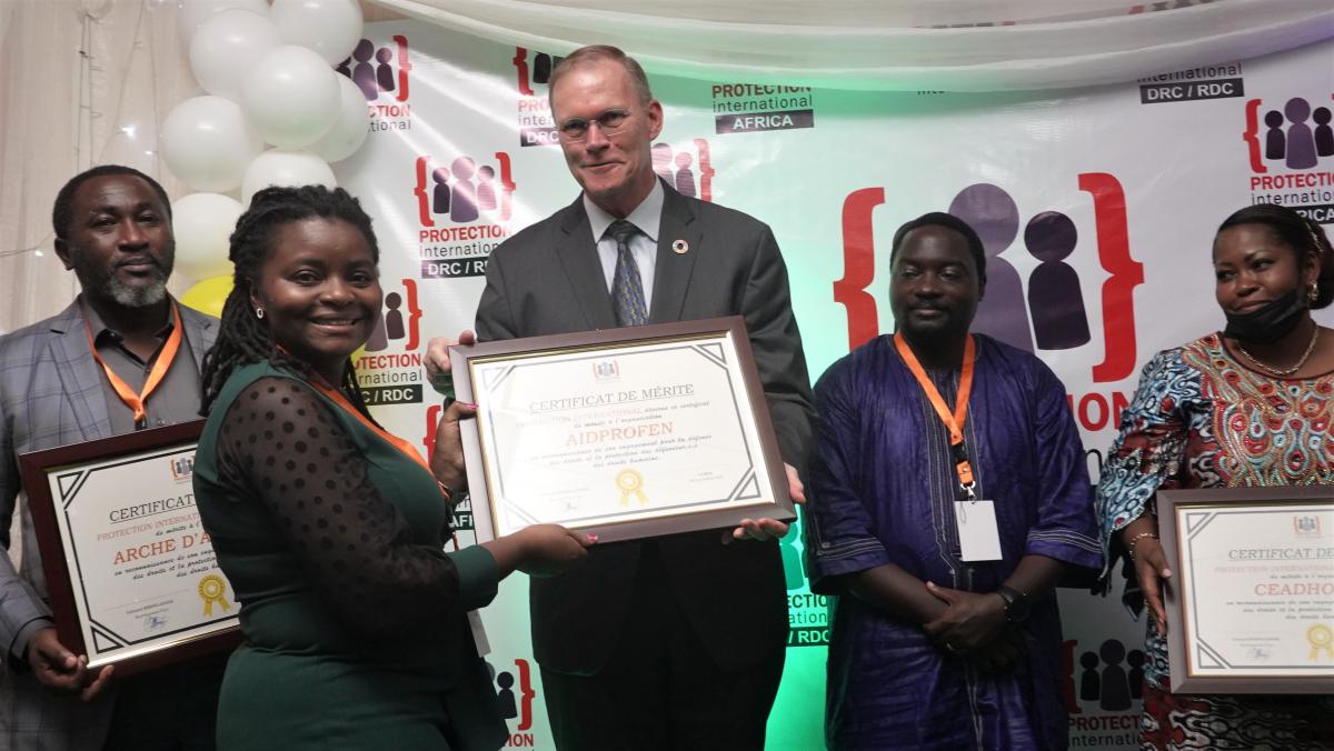 On 29 November 2021, Passy Mubalama, a Congolese Human Rights Defender (left) received Protection International's Award certificate in the hands of Jan Van Ranselaar, the Head of the Dutch Embassy Liaison Office in Goma (middle). Photo: Ephrem Chiruza/PI