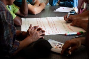 People working on a piece of paper